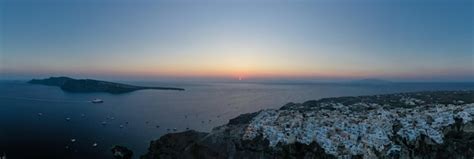 Premium Photo | Aerial view of the oia village at sunset on santorini ...