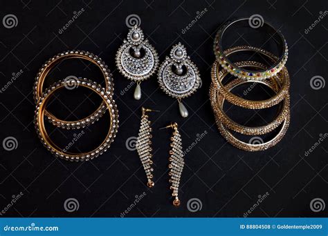 Designs of Earrings and Bangles Set Stock Photo - Image of composition ...