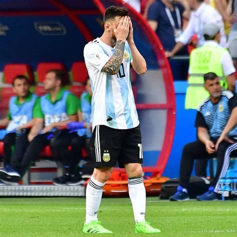 A Soccer Player Is Wiping His Face On The Field