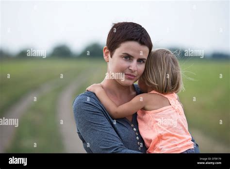 Mother holding daughter Stock Photo - Alamy
