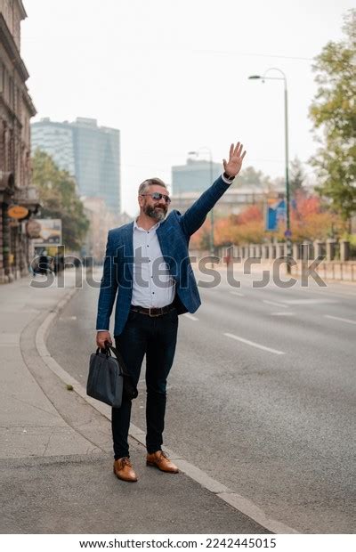 Handsome Mature Business Man Catch Taxi Stock Photo