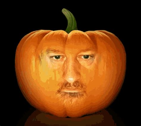 an orange pumpkin with a man's face carved into the top and bottom half