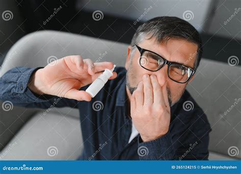 Portrait Of Man With A Nasal Spray Sick Man Using Nose Drops While