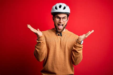 Young Blond Cyclist Man With Beard And Blue Eyes Wearing Bike Helmet