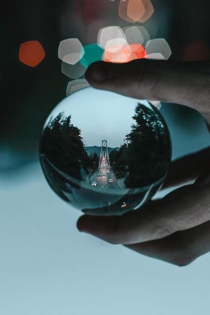 Premium Photo Close Up Of Hand Holding Glass With Reflection