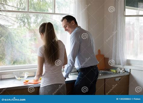 Wife And Husband Preparing Food Together In The Kitchen Stock Image