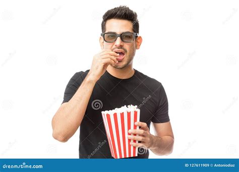 Handsome Young Man Eating Popcorn While Watching 3d Film Stock Image