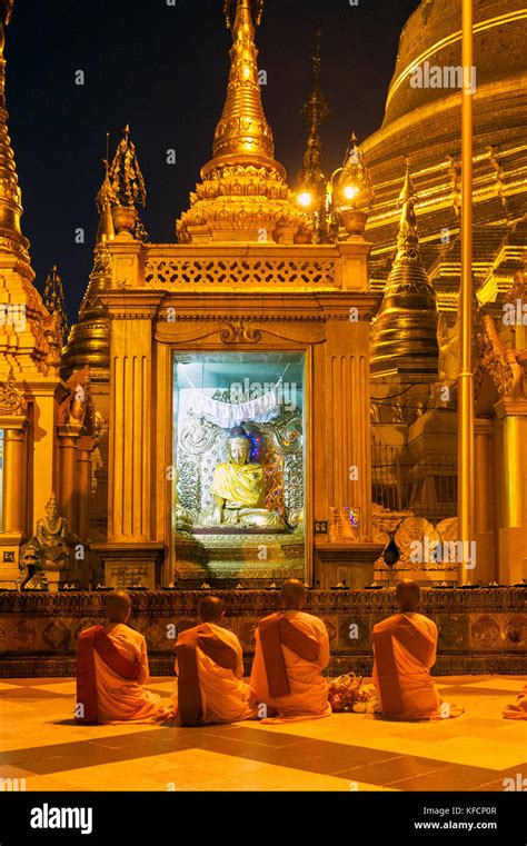 Myanmar Formerly Burma Yangon Rangoon Nuns Praying At Shwedagon Pagoda Buddhist Holy