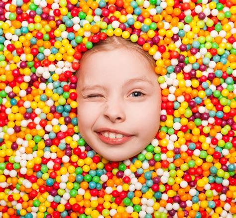 Premium Photo Winking Kid Posing In Candies