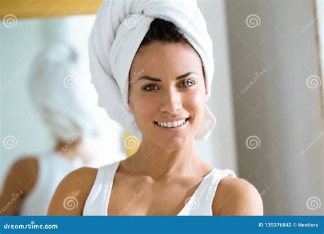 Attractive Young Woman Wrapped A Towel Around Head In Her Bathroom At