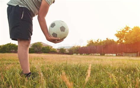 Caucasian Boy With A Soccer Ball On A Football Field Stock Photo