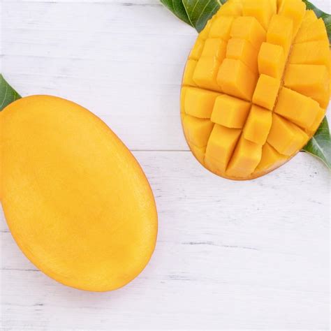 Premium Photo Beautiful Chopped Ripe Mango With Green Leaves On