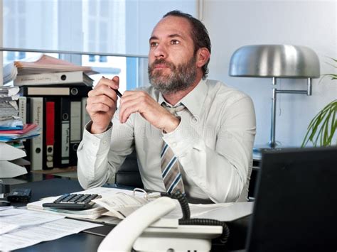 Businessman At His Desk Throws Documents And Papers Into The Air Stock