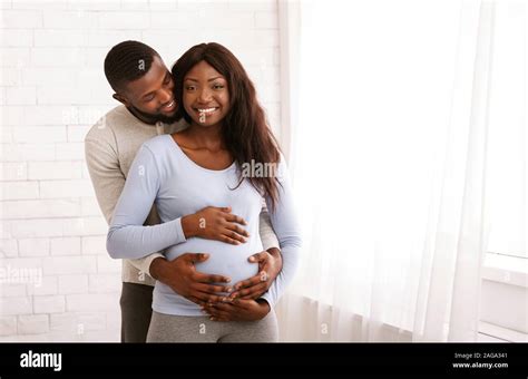 Man In Love Hugging His Pregnant Wife Over White Stock Photo Alamy