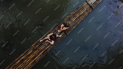 Premium Photo | Couples with bamboo raft in thailand during summer