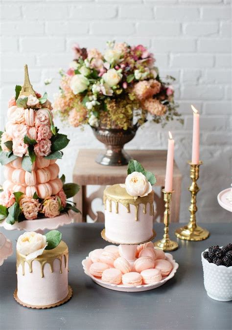 A Table Topped With Cakes Covered In Frosting Next To Candles And Other