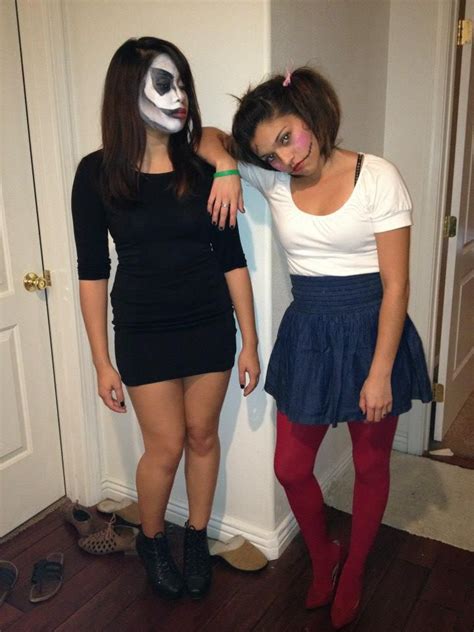 two women dressed up in halloween costumes standing next to each other with their faces painted