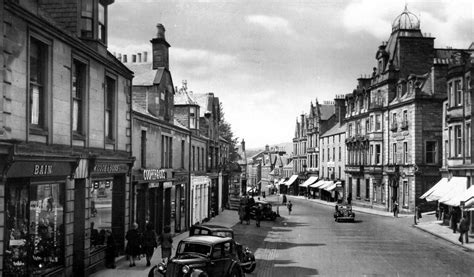 Old Photograph Of Cars And People In The High Street In Crieff Perthshire Scotland Old