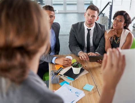 Team Of Successful Business People Having A Meeting In Executive Sunlit