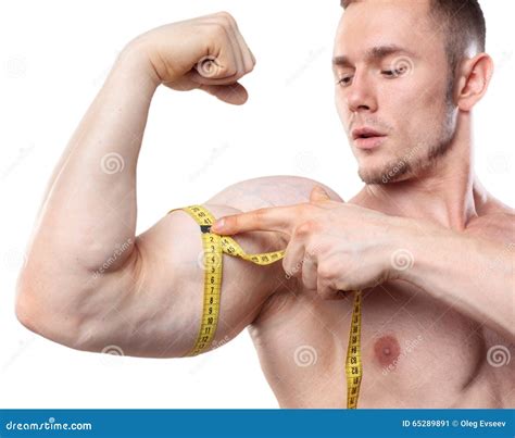 Image Of Muscular Man Measure His Biceps With Measuring Tape In