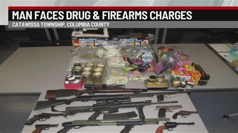 Man Arrested Drugs Cash And A Dozen Illegal Guns Seized During