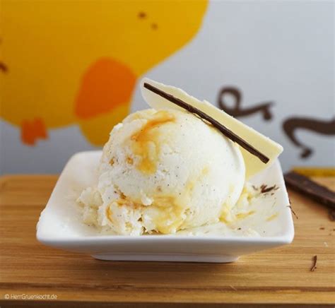 An Ice Cream Sundae On A White Plate With Some Chocolate Sticks