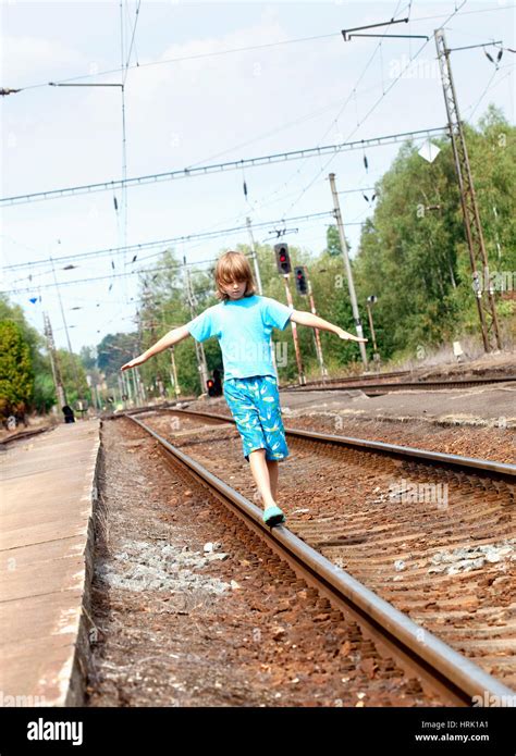 Young Boy Walking On The Railroad Track Stock Photo Alamy