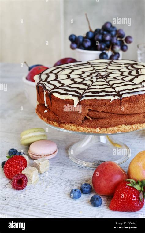 Halloween Chocolate Spider Web Cake And Various Fruits Around Party