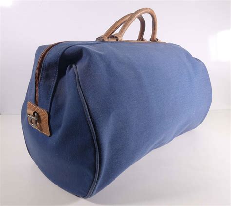 LANCEL Sac de voyage en toile bleue et cuir beige avec bandoulière