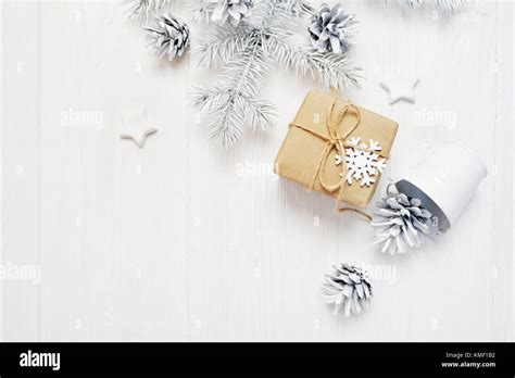 Mockup Christmas Kraft Gift And Tree Cone Flatlay On A White Wooden