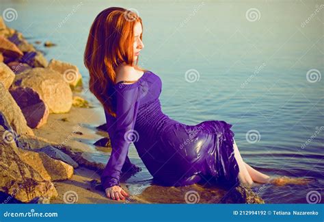 Woman In Purple Long Dress At Nature Fashionable Concept Stock Photo