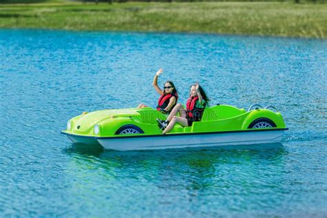 Girls in Safety Jackets Wave and Ride a Pedal Boat on a Mountain Lake Stock Photo - Image of ...