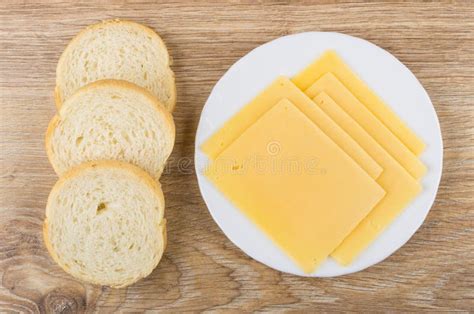 Slices Of Cheese In White Plate And Pieces Of Bread Stock Image Image