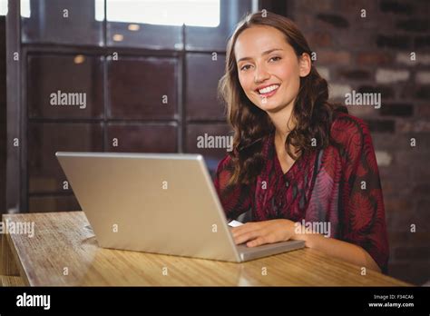 Smiling Brunette Using Laptop Stock Photo Alamy
