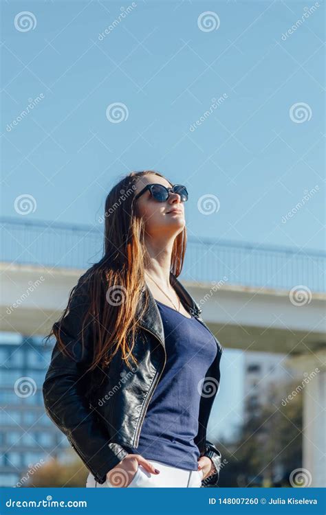 Outdoor Portrait Of A Young Beautiful Confident Woman Posing On The