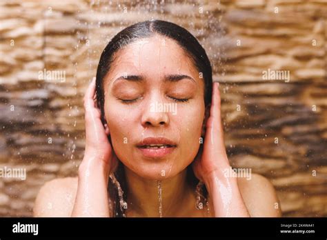 Happy Biracial Woman Taking Shower Washing Hair In Bathroom Stock