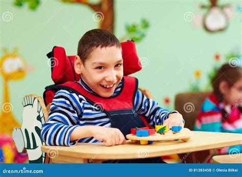 Portrait Of Cheerful Boy With Disability At Rehabilitation Center For