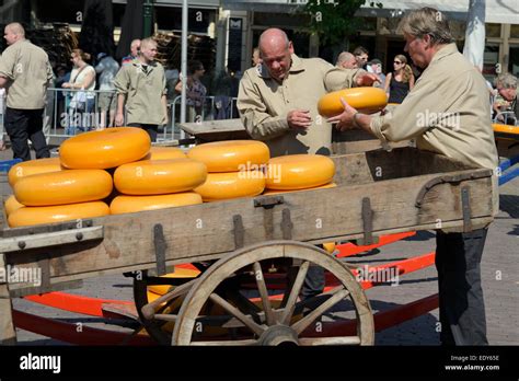 Loading Cheese Wheels Onto A Traditional Wooden Cart Waagplein Square