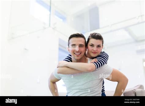 Handsome Man Piggybacking His Girlfriend Stock Photo Alamy