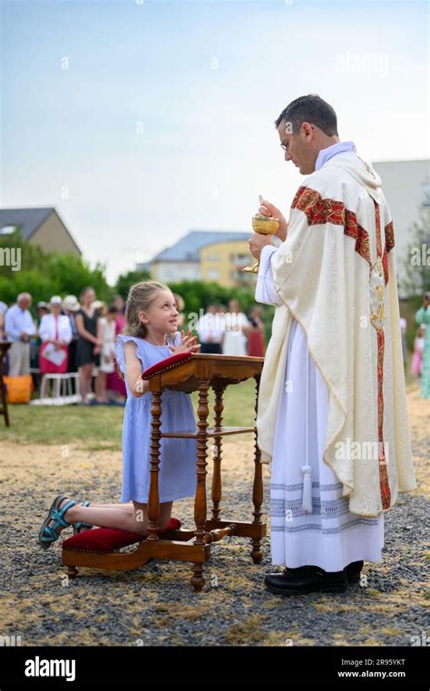 A Child Receiving The First Holy Communion Stock Photo Alamy