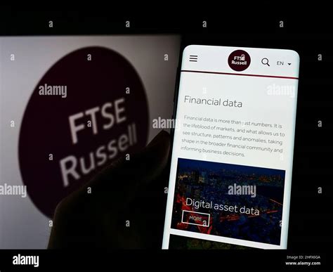 Person Holding Smartphone With Webpage Of British Company FTSE Russell