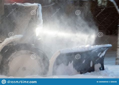 Snow Removal In Winter Front View Of A Snowplow Of City Services