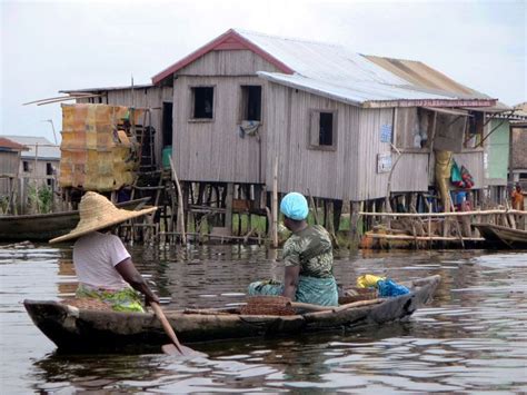 Tofinu Women Paddle Through Ganvie On Lake Nokoue Near Cotonou Benin