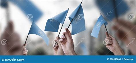 A Group Of People Holding Small Flags Of The International Intellectual