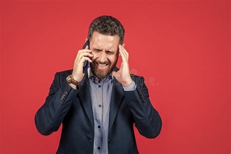 Sick And Tired Stressed Bearded Businessman In Suit Speak On Phone