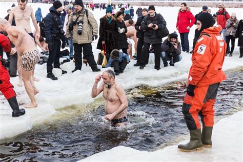 Russian People Are Dipped Into An Ice Hole On The Day Of The Epiphany