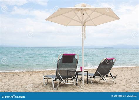 Blue Sea And White Sand Beach With Beach Chairs And Umbrella Gr Stock