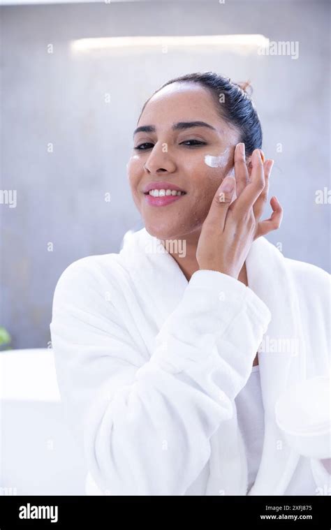 Applying Face Cream Woman In Bathrobe Enjoying Spa Treatment Stock