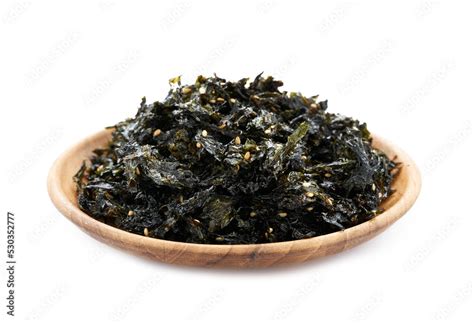 Roasted Nori Seaweed And Sesame Topping In Wood Plate Isolated On White