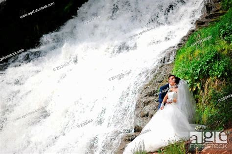 Beautiful Wedding Couple Near Waterfall Stock Photo Picture And Low